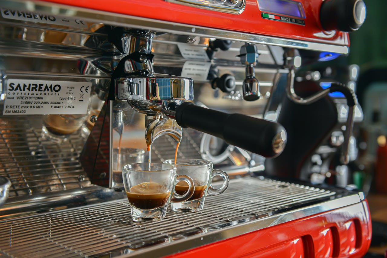 Close-up of espresso being poured into cups from a Sanremo espresso machine.