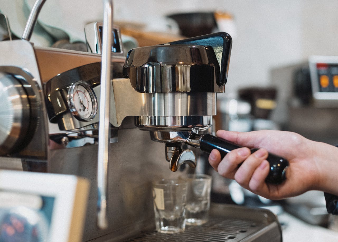 Barista preparing espresso with a professional machine in a Tokyo coffee shop.